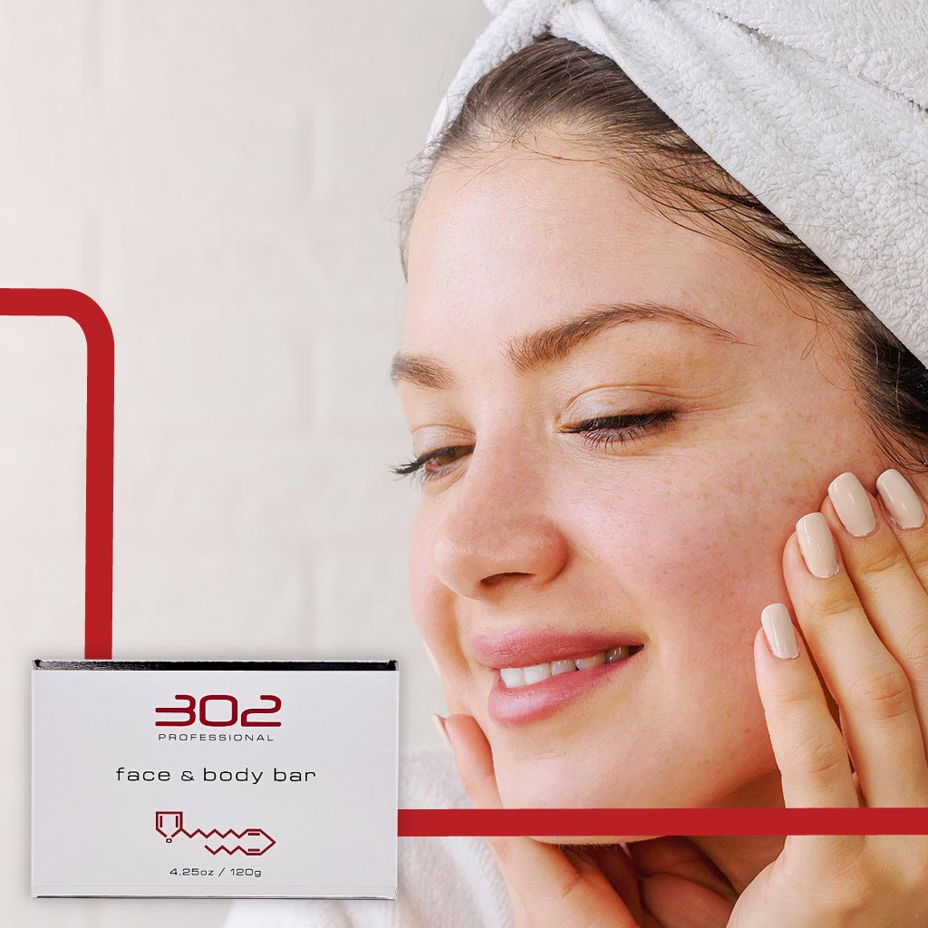 BAR-425OZ_WOMAN_2_1024x1024_72 | 302 Professional Skincare Woman with a towel on her head touching her cheek beside a white box labeled '302 Professional face & body bar' (skincare ad image).