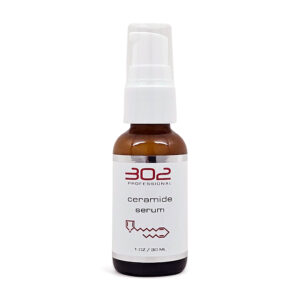 Brown glass spray bottle labeled 'ceramide serum' with white pump, 1 oz / 30 ml, standing upright against a white background